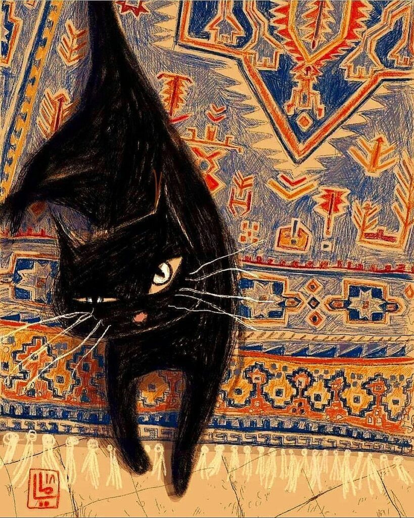 sur un tapis coloré, un chat lève la tête et ouvre un oeil