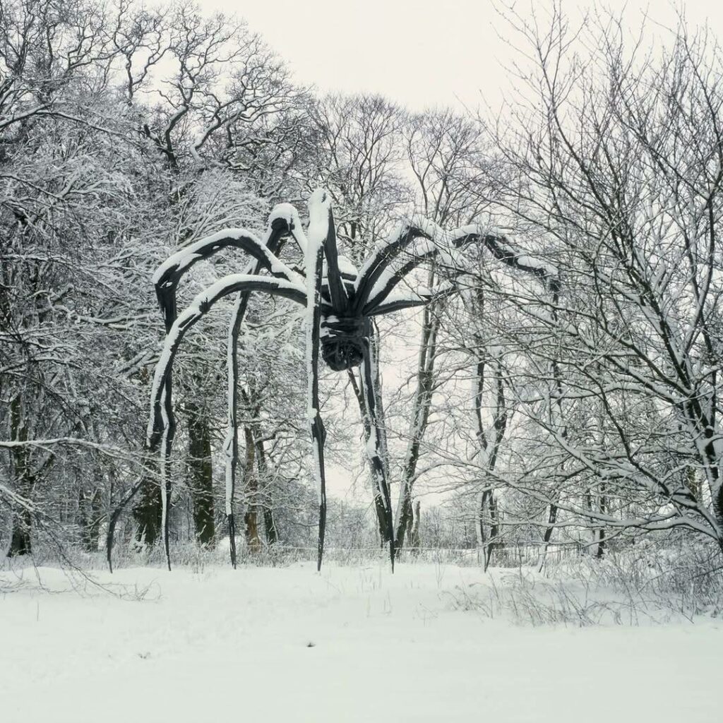 debout dans la neige, immobile entre les arbres, «Maman», une gigantesque araignée, sculpture contemporaine de la plasticienne Louise Bourgeois